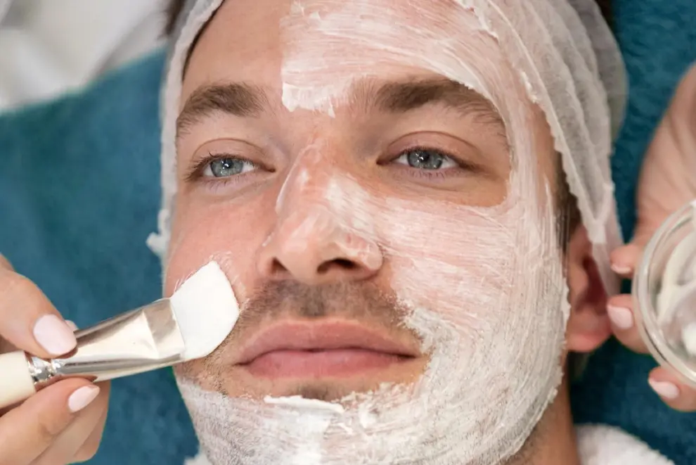 A man with a white face mask on.