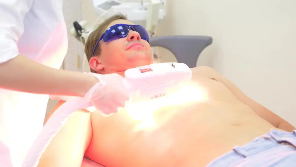 A man getting his face and chest laser hair removal.