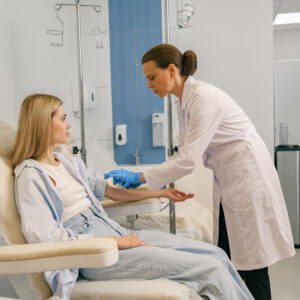 Healthcare professional preparing to administer treatment.